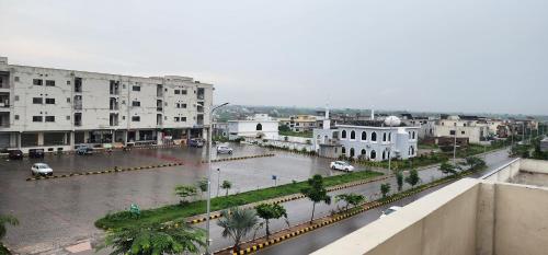 a city with a flooded street with buildings at Haven Lodge, Islamabad in Islamabad