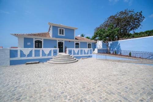 a house with a blue and white wall at Azores Book Hotel in Angra do Heroísmo