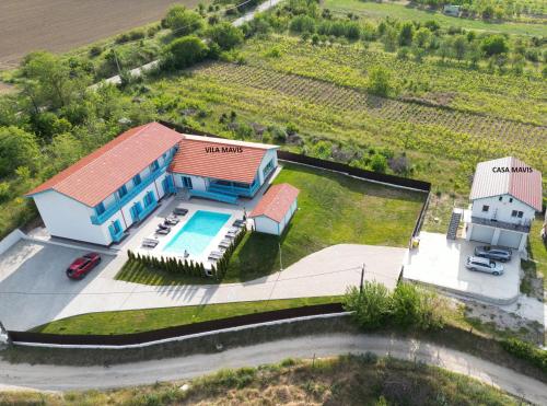 an aerial view of a house with a swimming pool at Vila Mavis-cazare cu piscina incalzita 1 mai-30 sept in Mahmudia