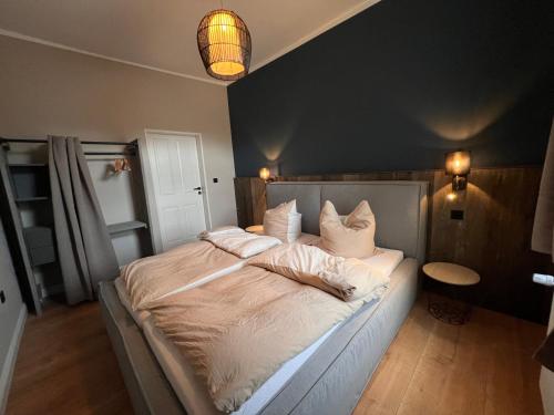 a bedroom with a large bed with white sheets and pillows at VILLA am Paulsberg mit Sauna - V4 in Braunlage