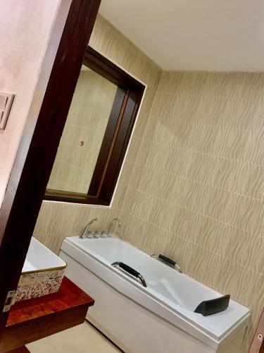 a bathroom with a white sink and a mirror at Happy hour boutiquehotel in Luang Prabang