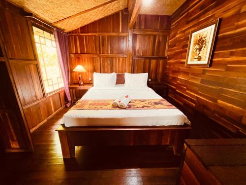 a bedroom with a bed with a stuffed animal on it at Villa Gajah Mas in Baturiti