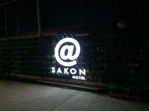 a sign for a saxon hotel at night at At Sakon Hotel in Sakon Nakhon