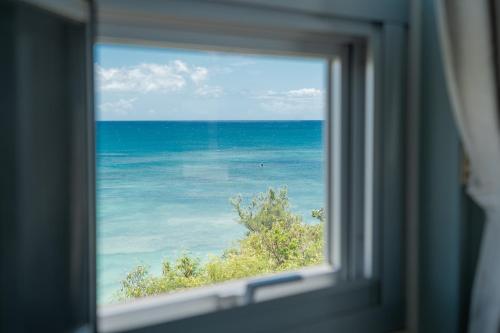a view of the ocean from a window at マリナベイToya in Toya