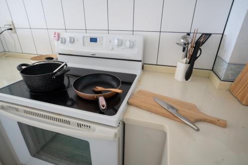 a kitchen with a stove with pots and pans on it at マリナベイToya in Toya