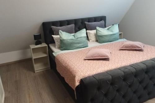 a bedroom with a large bed with pillows on it at Ferienhaus Zum Birkenwäldchen in Kützkow