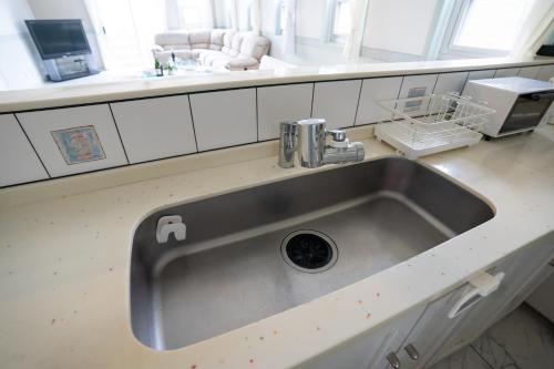 a kitchen sink with a faucet on top of it at マリナベイToya in Toya
