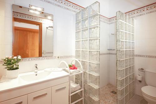 a bathroom with a sink and a shower at Finca con piscina Es Baladre in Capdepera