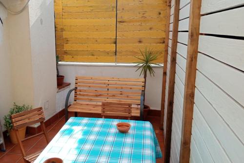 a small porch with a table and a bench at MAMIS in Catania