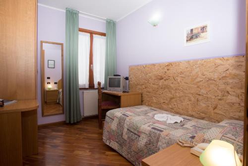 Postel nebo postele na pokoji v ubytování Hotel Pigna D'Oro