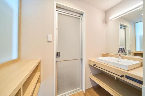 a bathroom with a sink and a mirror at Meitetsu Inn Nagoya Kanayama Annex in Nagoya