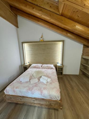 a bedroom with a bed with two pillows on it at B&B antico tabià dolomitico in Santo Stefano di Cadore