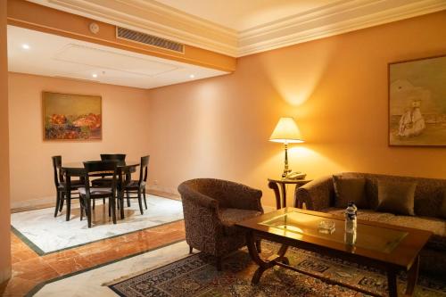 a living room with a couch and a table at Regency Tunis Hotel in Gammarth