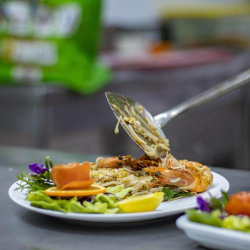 a plate of food on a table with a spoon at Regency Tunis Hotel in Gammarth