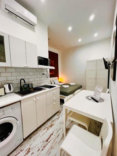 a kitchen with a washer and dryer and a table at Quiet Luxury Apartment with 2 rooms in the City Centre BB in Budapest