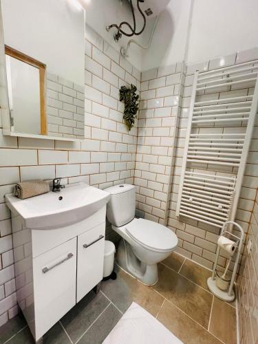 a white bathroom with a toilet and a sink at Quiet Luxury Apartment with 2 rooms in the City Centre BB in Budapest