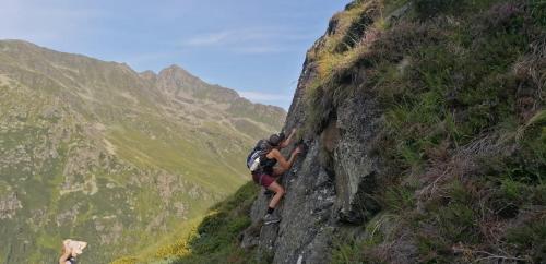 a couple of people climbing up a mountain at Almen-Kräuter-Oberreiter in Dellach im Drautal