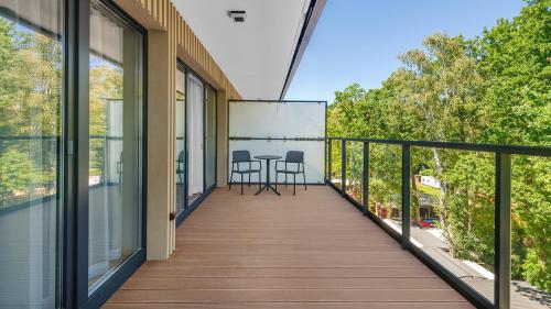 a balcony with a table and chairs on it at Apartamenty Helski Brzeg in Hel