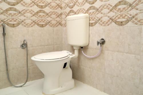 a bathroom with a toilet and a shower at TRPOTELS Town Inn in Gwalior
