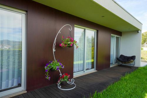 a balcony with flowers on the side of a house at House on the Top Guimarães in Guimarães