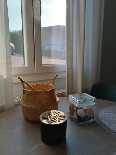 a table with a basket and eggs and a window at Little Dream House in Valanidorachi