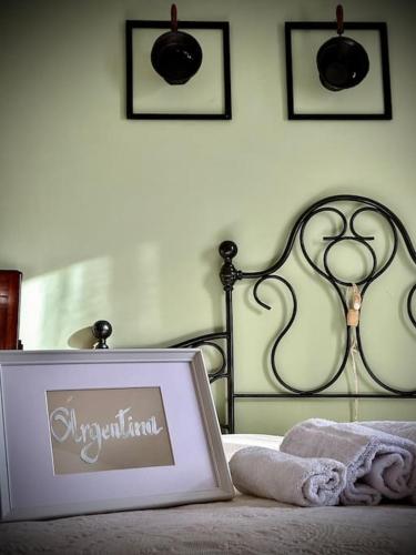 a picture of a bed with a sign on it at Podere Casa Rossa a Pienza in Pienza