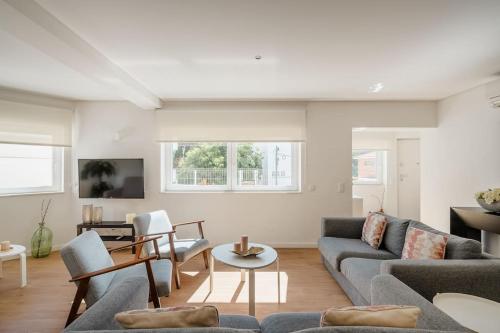 a living room with a couch and a table at Villa Miramar - Seaside Cascais in Cascais