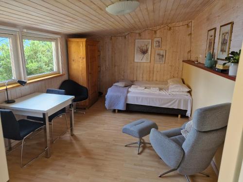 a room with a bed and a table and chairs at Stranda apartment in Stranda