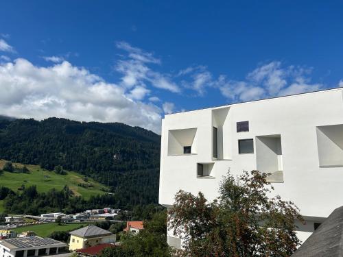 a white building with a view of a mountain at Kloster Ilanz in Ilanz