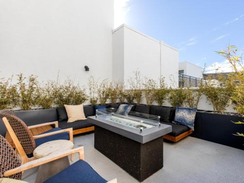 a patio with a couch and a table and chairs at Redondo Beach 1BR w Pool Gym 1 block from beach LAX-437 in Redondo Beach
