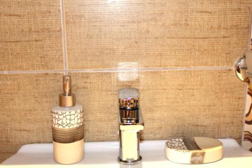 a bathroom with a blow dryer on a counter at Fissas Rooms in Sivota