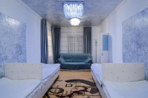 a living room with two beds and a couch at Naryn Cozy House in Naryn