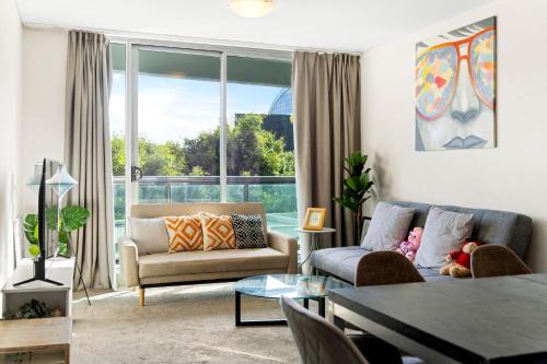 a living room with a couch and a table at Sydney CBD 3BR Apt - 150m to Darling Harbour & ICC in Sydney