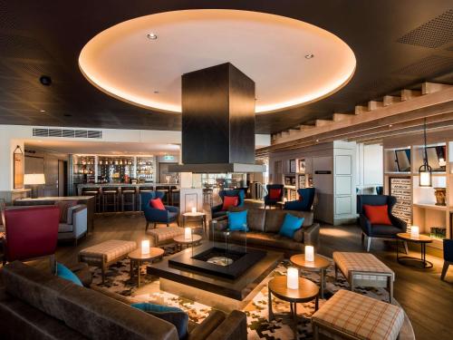 a hotel lobby with couches and a bar at The William Inglis Mgallery in Warwick Farm