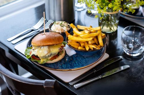 a plate with a sandwich and french fries on a table at The Upper Largo Hotel & Restaurant in Lundin Links