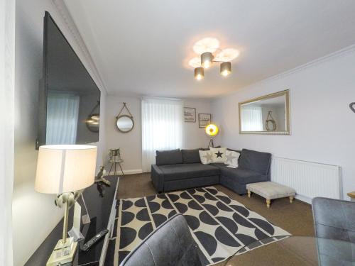 a living room with a couch and a table at The Upper Largo Hotel & Restaurant in Lundin Links