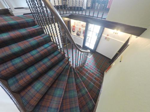 an overhead view of a spiral staircase in a house at The Upper Largo Hotel & Restaurant in Lundin Links