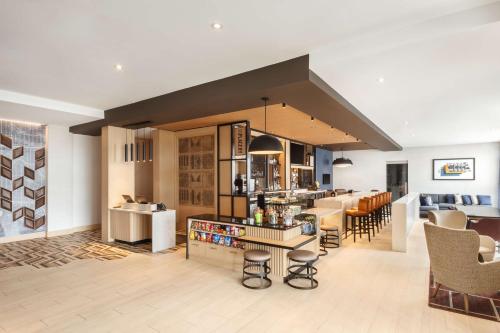 a kitchen and living room with a counter and chairs at Hyatt Place Munster in Munster