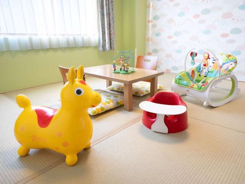 a childs bedroom with a toy duck and a crib at Grand Mercure Nasu Highlands Resort & Spa in Nasu