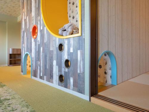 a childs room with a play room with a wall with a castle at Grand Mercure Nasu Highlands Resort & Spa in Nasu