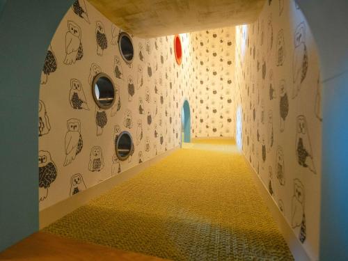a hallway with drawings on the walls of a room at Grand Mercure Nasu Highlands Resort & Spa in Nasu