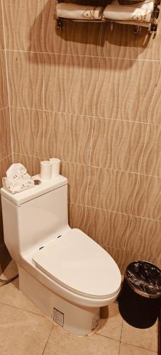 a bathroom with a white toilet in a room at Happy hour boutiquehotel in Luang Prabang