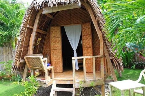 a small hut with a chair and a table at Shanyem in Mon