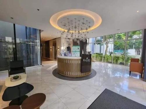 a lobby with a chandelier and a bar in a building at Chill Spot Staycation in Pasig in Manila