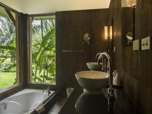 a bathroom with a tub and a sink and a window at Villa Galanga 3 Bedrooms Plus Cottage Room in Ao Nang Beach