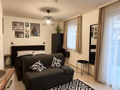 a living room with a couch with pillows on it at Apartment Alpzbase in Kaprun