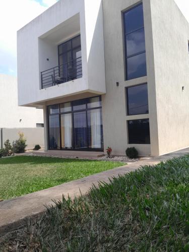 a house with a balcony on the side of it at Dafrican BnB villa in Kigali