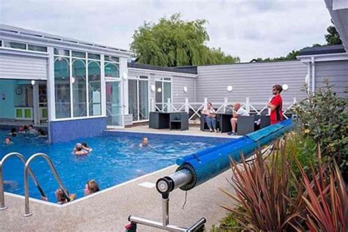 a pool with a large blue water slide at Place2bee , Caravan , Manor park , Free Wifi ,6 Berth in Hunstanton