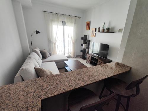 a living room with a couch and a television at Garrucha Home in Garrucha