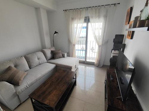 a living room with a couch and a coffee table at Garrucha Home in Garrucha